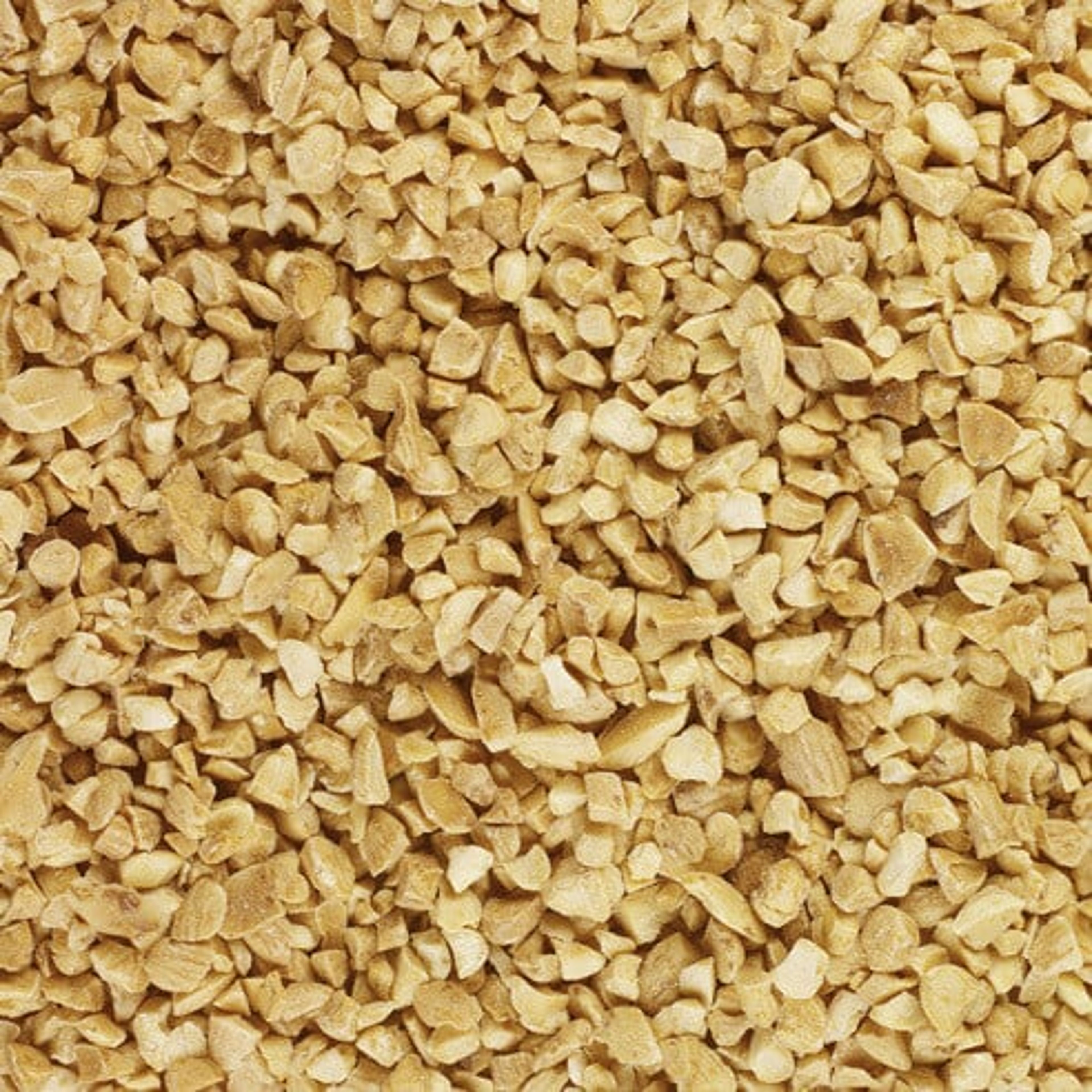 A close-up view of finely chopped roasted peanuts.